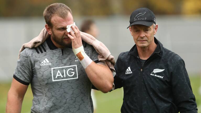 LONDON, ENGLAND - NOVEMBER 06: Joe Moody is assisted by Dr Tony Page after suffering a bad cut to his eye during a New Zealand All Blacks training session at the Lensbury Hotel on November 6, 2018 in London, England. (Photo by Phil Walter/Getty Images)