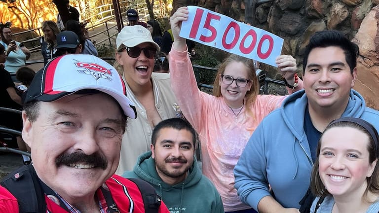 Jon Alan Hale, left, poses with friends after taking his 15,000th Radiator Springs Racers ride at Disney California Adventure in Anaheim, California. (Source: Jon Alan Hale via AP)
