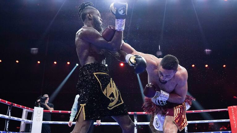Parker lands an overhand right against Wilder in Riyadh.