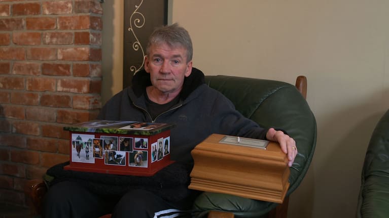 Kevin Boyle holding the ashes of his wife, Tania Boyle, and their son, James Clarke.
