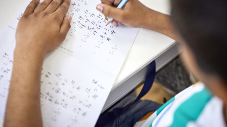 Kumon student solving a maths worksheet at a centre.