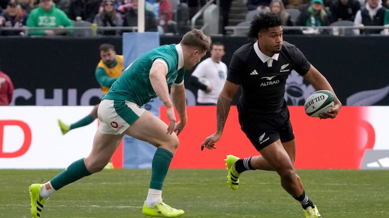 Leicester Fainga'anuku gets past Ireland's Garry Ringrose in Chicago.