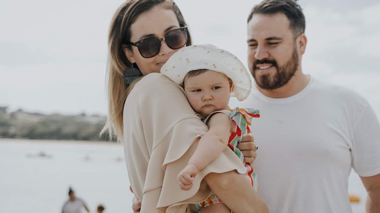 Lizzie Strickett (left) and Peter van Kampen (right) with their baby.