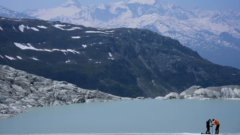 Matthias Huss and Monica Ursina Jaeger prepare a camera at the Rhone Glacier near Goms, Switzerland, on June 10, 2025.