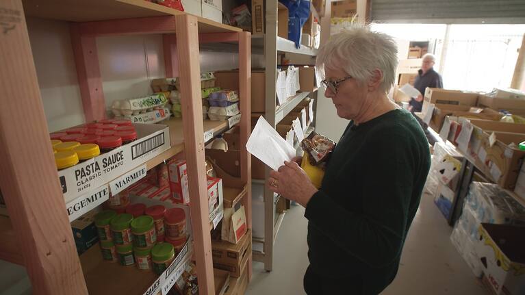 Foodbank extraordinaire May Croft stocks the shelves.