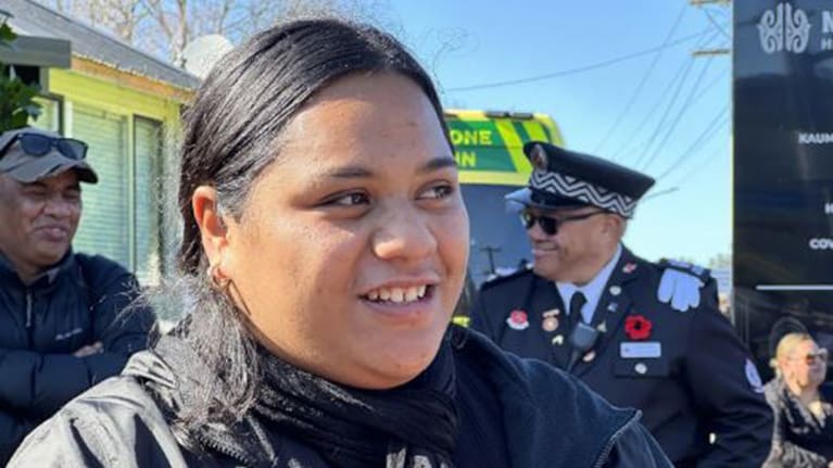 Moesha Wharawhara-Gate smiles as she watches the new queen ascend the throne.