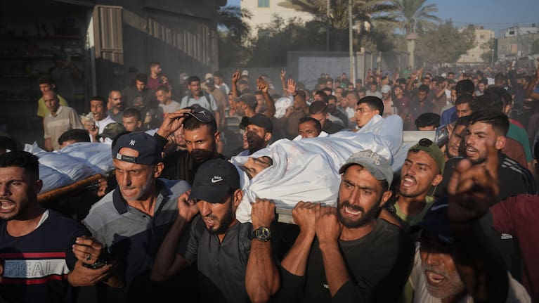 Mourners carry bodies of Palestinians killed by Israeli fire, during their funeral in Deir al-Balah, Gaza Strip, Sunday, Oct. 19, 2025