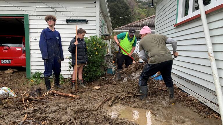 Residents in Nile Street, Nelson clean up after the recent severe weather.