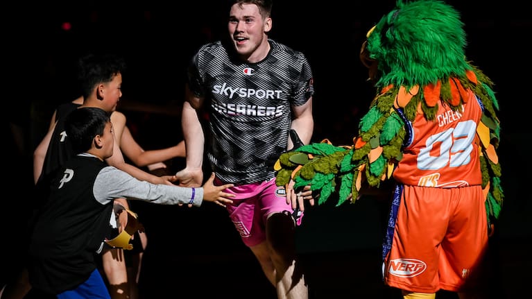 Alex McNaught runs onto the court before a match against Tasmania.