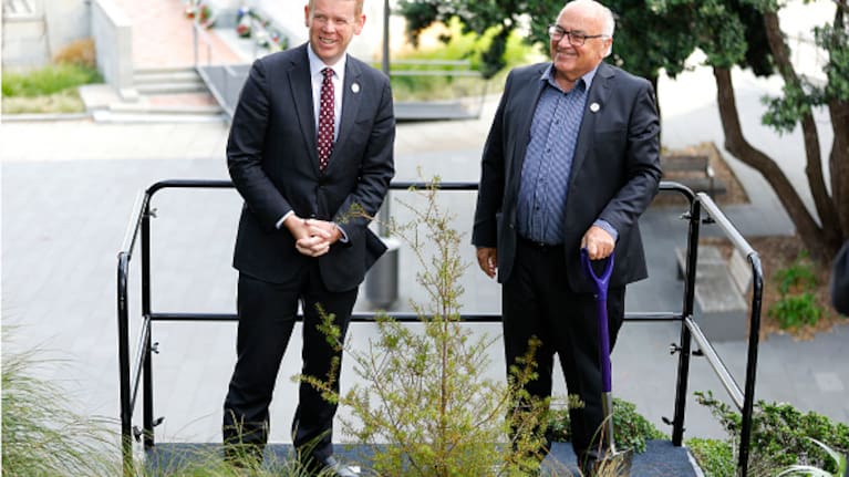 Prime Minister Chris Hipkins and Trees That Count's Joris De Bres plant a tree at Parliament to mark King Charles III's coronation.