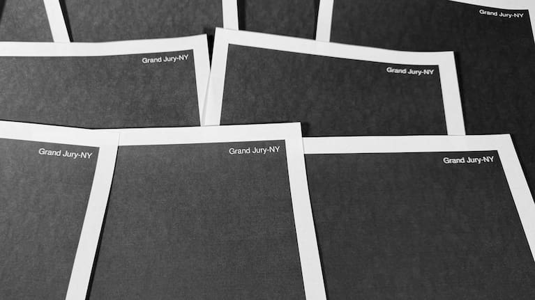 Pages from a totally redacted New York grand jury file into Jeffrey Epstein and Ghislaine Maxwell, released by the US Justice Department, is photographed.