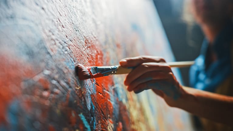 A person painting on a canvas (file image).