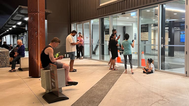 People attempt to connect to the outside world via airport wi-fi following Cyclone Gabrielle
