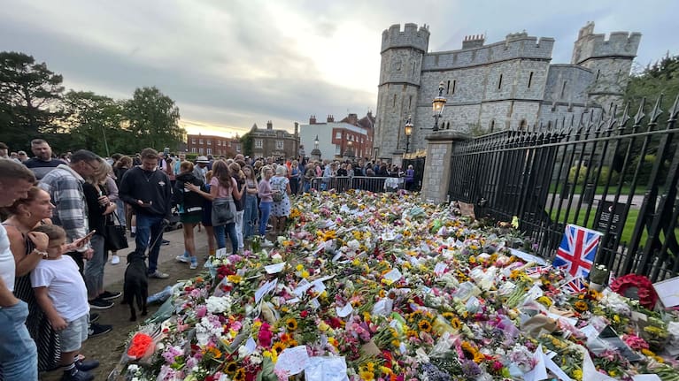 People look at all of the tributes for Queen Elizabeth II in Windsor.
