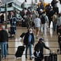 People make their way through a terminal at San Diego International Airport.