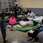 People take shelter in a school ahead of Hurricane Melissa's forecast arrival in Old Harbour, Jamaica.