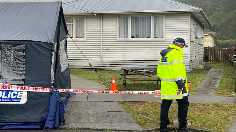 A blue police tent has been put up in front of the property.