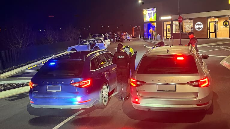 Police officers check vehicles amid a boy-racer crackdown.