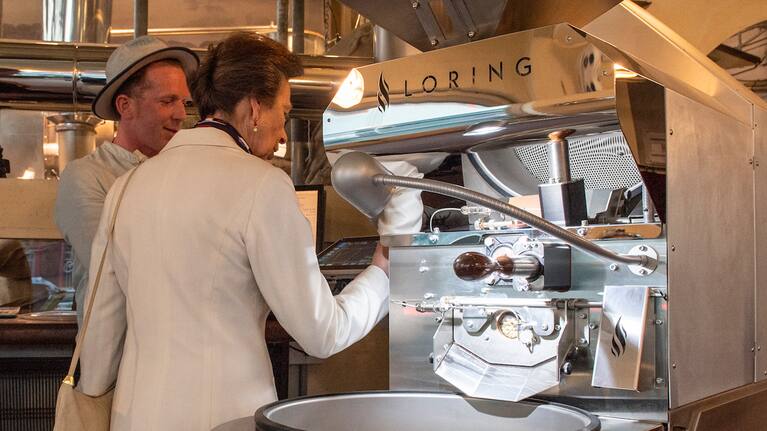 Princess Anne roasting coffee in Wellington.