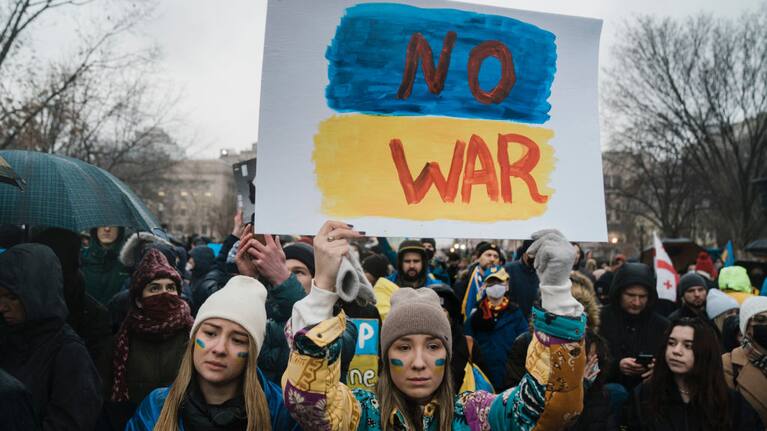 Elena Quiles and Oleksandra Yashan, both of Arlington join other demonstrators gather at the White House to protest against Russia's invasion of Ukraine.