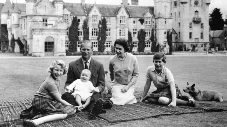 Queen Elizabeth II, Prince Philip and their children, Prince Charles, right, Princess Anne and Prince Andrew, pose for a photo on the lawn of Balmoral Castle, in Scotland, in 1960.