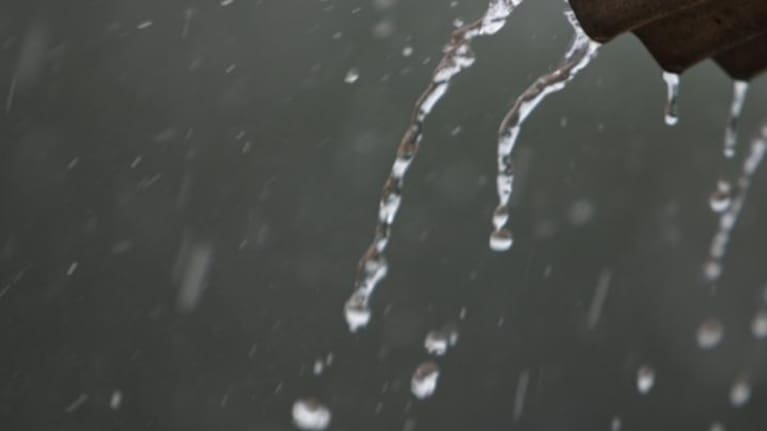 Rain pouring off a roof.