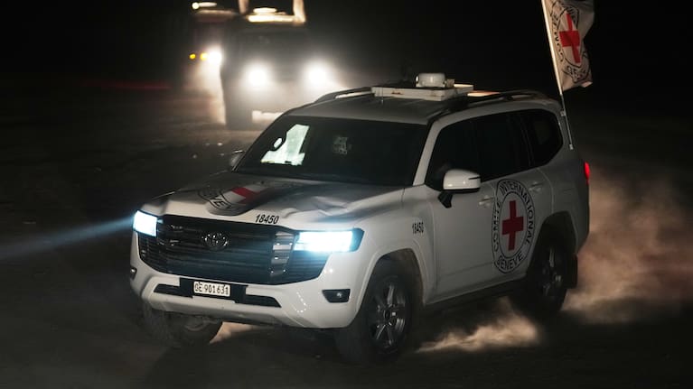 Red Cross vehicles carrying the bodies of three people believed to be deceased hostages handed over by Hamas make their way toward the border crossing with Israel, to be transferred to Israeli authorities, in Deir al-Balah, central Gaza Strip.