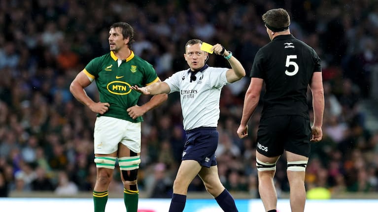 Referee Matthew Carley shows Scott Barrett a yellow card at Twickenham.