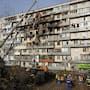 Rescuers work on the scene of a building damaged after a Russian attack in Kyiv, Ukraine, on Friday, November 14, 2025.