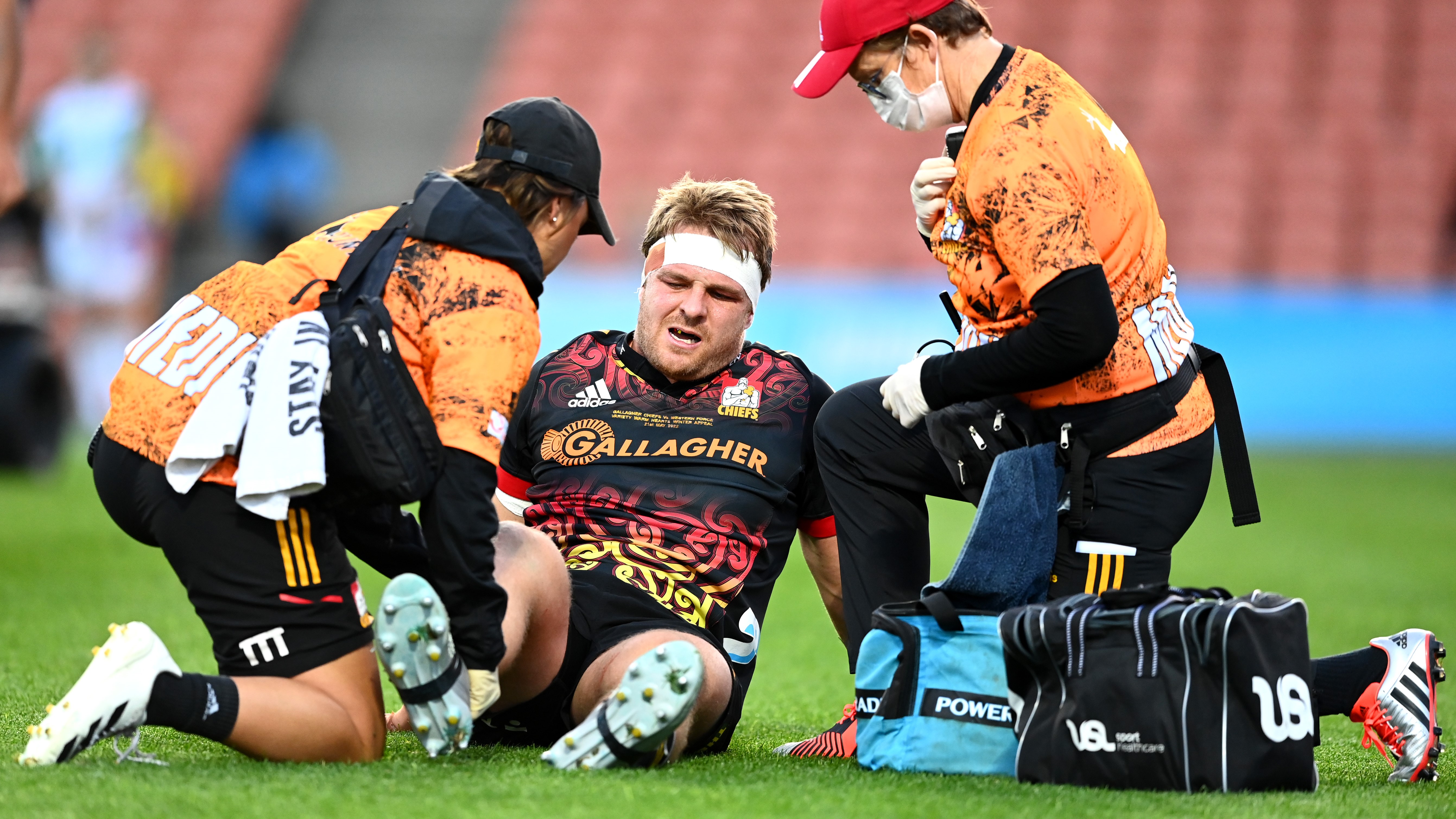 Sam Cane receives medical attention after suffering a knee injury against the Force.