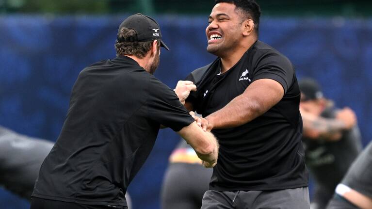 All Blacks hooker Samisoni Taukei'aho attempts to escape the clutches of trainer Nic Gill in training.