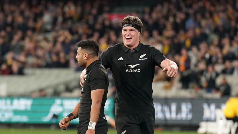 Scott Barrett celebrates the All Blacks' victory over Australia at the Melbourne Cricket Ground with teammate Richie Mo'unga.