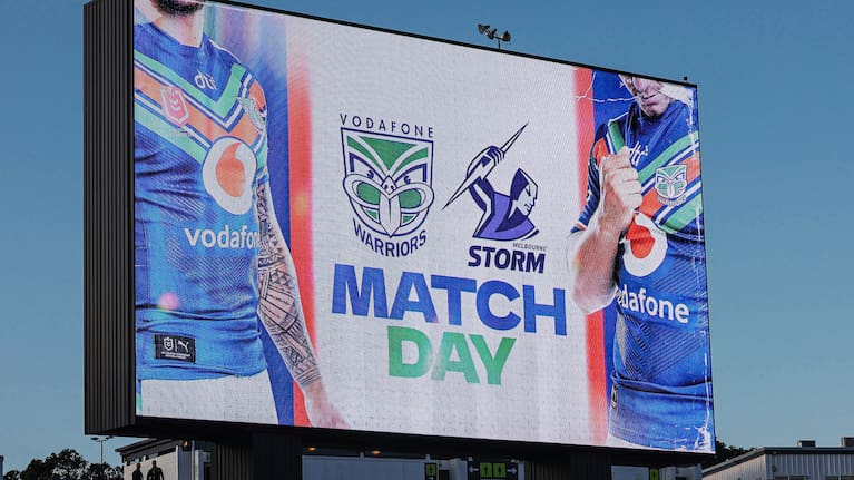 Signage promoting a match between the Warriors and Storm.