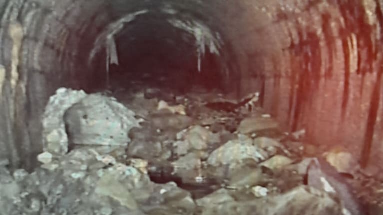 A CCTV image from within the Orakei sewer pipe shows the pipe full of debris.