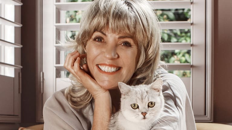 Stacy with her cat Pusskin, who shares his name with the lead character in her latest book.