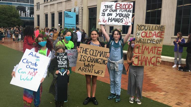 Protestors stand with their signs at the Wellington March.