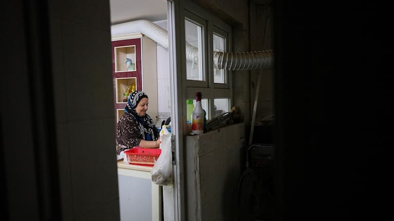Syrian refugee Hayat Fatah, 65, cleans dishes at her home in Irbil, Iraq, Nov. 16, 2025