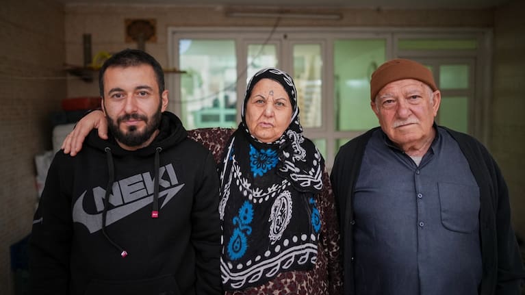 Syrian refugee Mohammed Dawood, 30, left, poses for a photo with his parents, Hayat Fatah, 65, center, and Abdulilah Amin Dawoud, 73, at their home in Irbil, Iraq