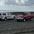 The damaged truck being towed on Auckland's Muriwai Beach.
