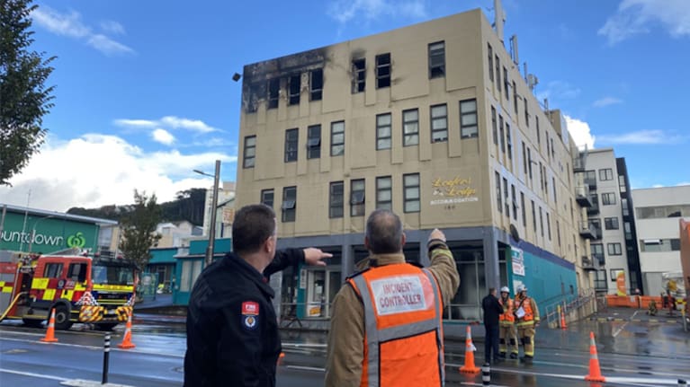 The Fire and Emergency New Zealand incident controller points at the Loafers Lodge in Newtown, Wellington.