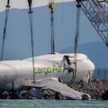 The wreckage of a cargo aircraft that skidded off a runway at the Hong Kong International Airport is prepared for removal.