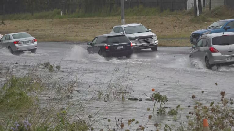 Cars driving in Auckland floodwaters on Friday.