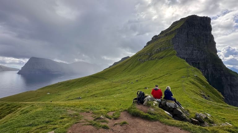 Tourists enjoy a view on Kalsoy Island at the Faroe Islands.