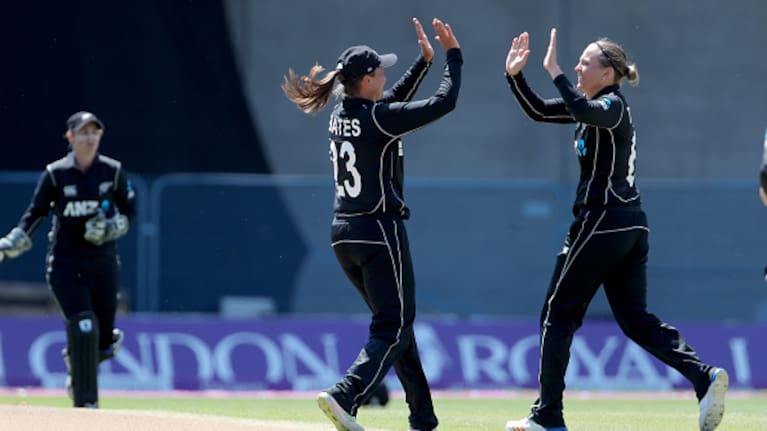 White Fern Lea Tahuhu celebrates with teammate Suzie Bates after taking a wicket in their match against England.