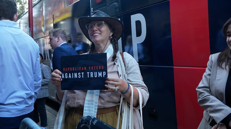 Woman carries 'Republican Voters Against Trump' sign