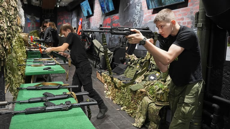 Young men practice with training Kalashnikov assault rifles at a museum of Russian Special Military Operations in Ukraine in St. Petersburg, Russia.